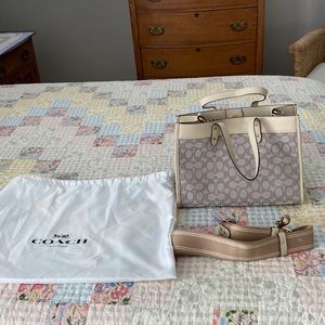Brand new Coach bag, strap, and original Coach storage bag. Muted tan colors.